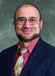 Dr. Saad Farhat wearing suit and orange shirt - headshot