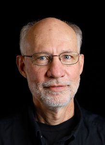 headshot of dr. randall goering with black background health ministries clinic newton ks nmc health campus