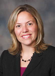 Dr. Jennifer Koontz in pinstripe suit jacket and maroon shirt - headshot