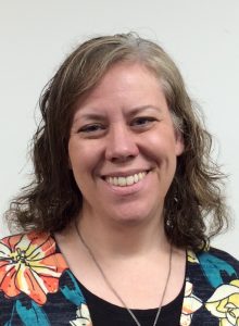 Woman in blouse with flowers smiling