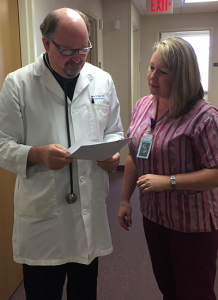 Dr. Mark Hall and nurse looking at patient files