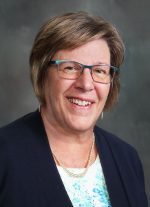 Jenny Martens, PA in dark blue cardigan and white shirt - headshot