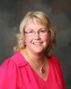 Faith Loommis in hot pink shirt - headshot