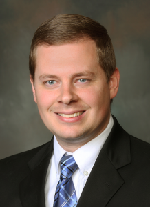 Dr. Chris Stanley in blue button up shirt - headshot