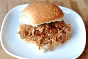 pulled pork sandwich on white plate