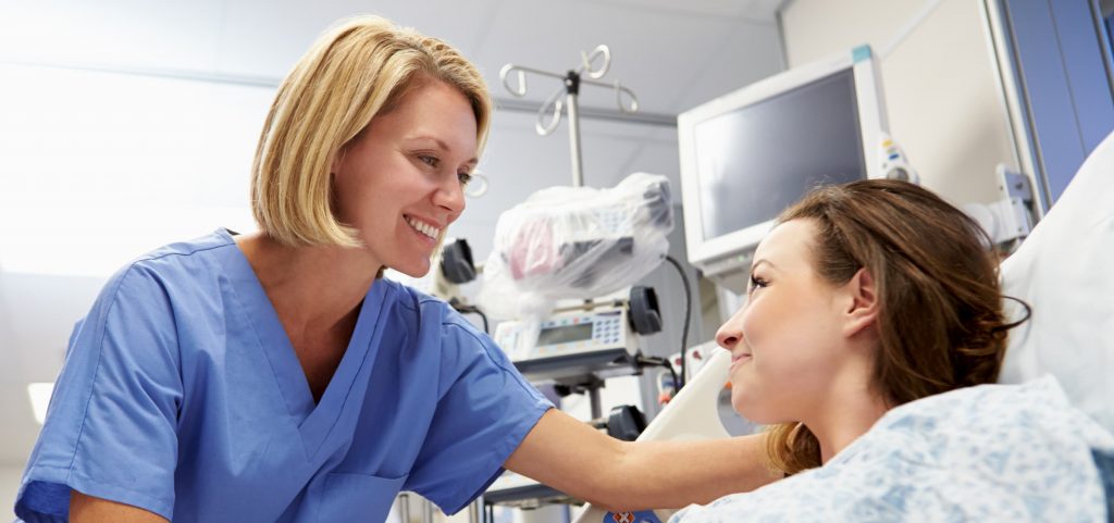white nurse with white patient in hospital bed