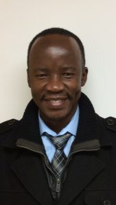 Man in black jacket smiling
