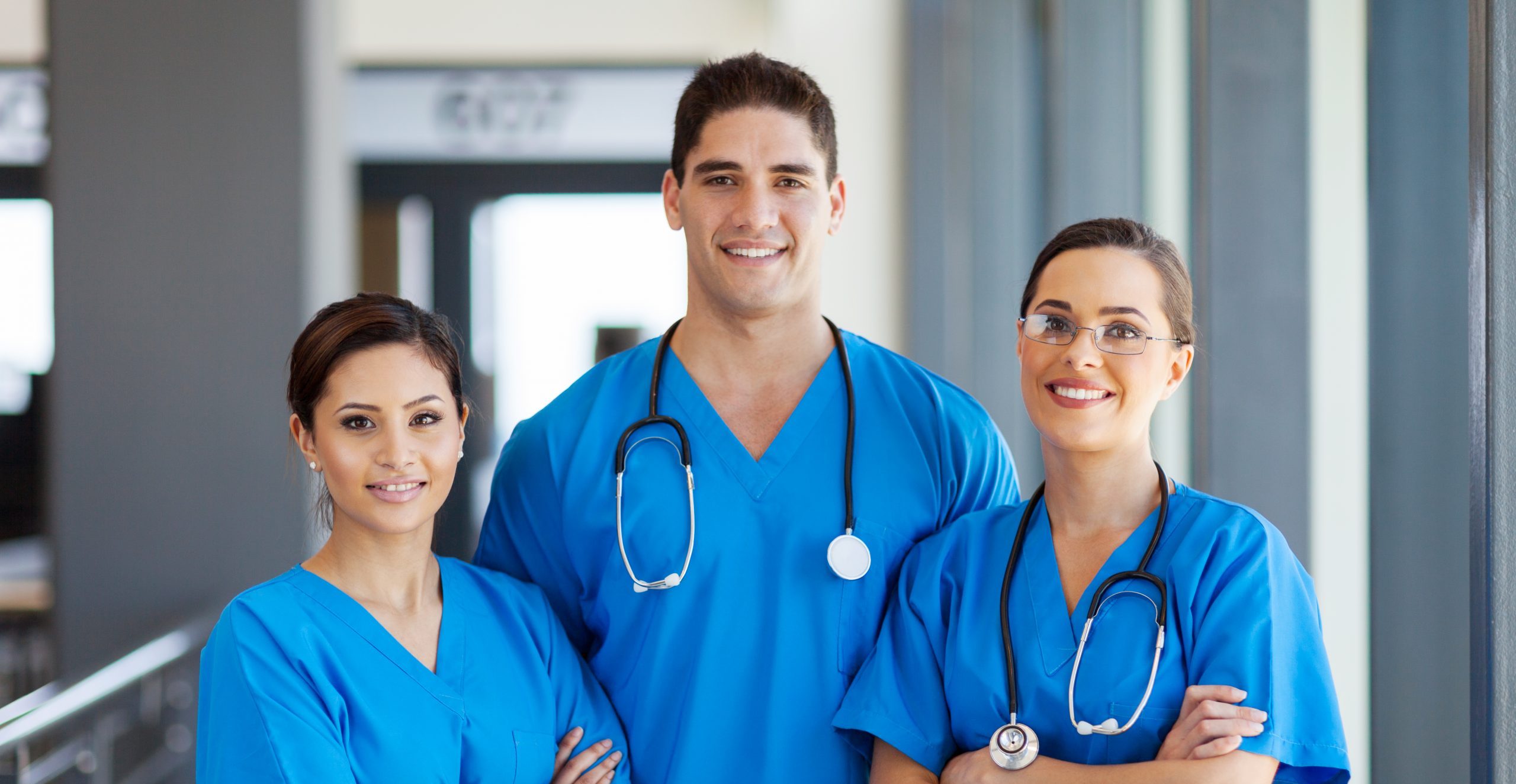 diverse group of doctors/nurse in blue scrubs hispanic white and arab