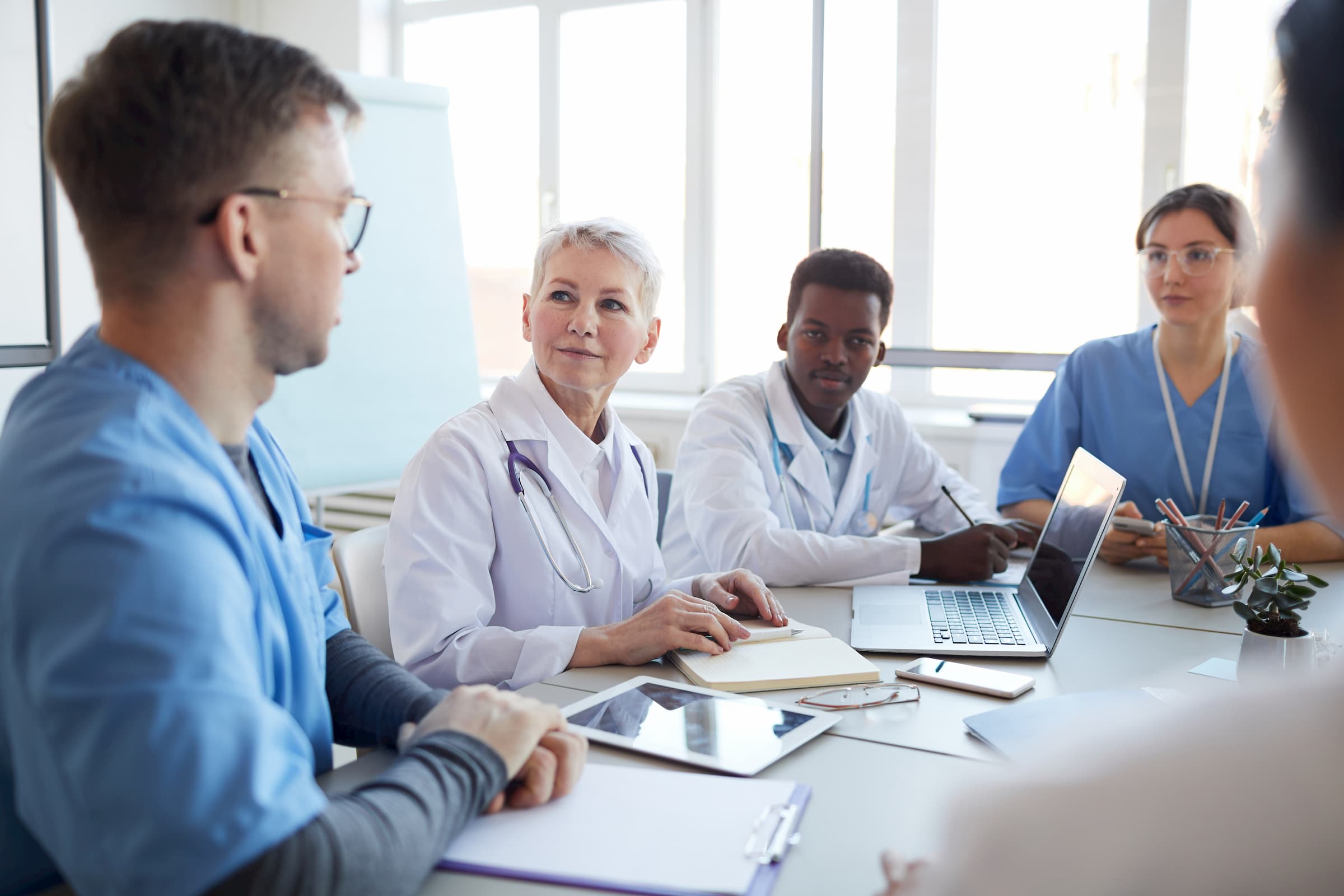 Royalty-free stock photo ID: 1674031606 Portrait of mature female doctor heading committee meeting at medical council, copy space