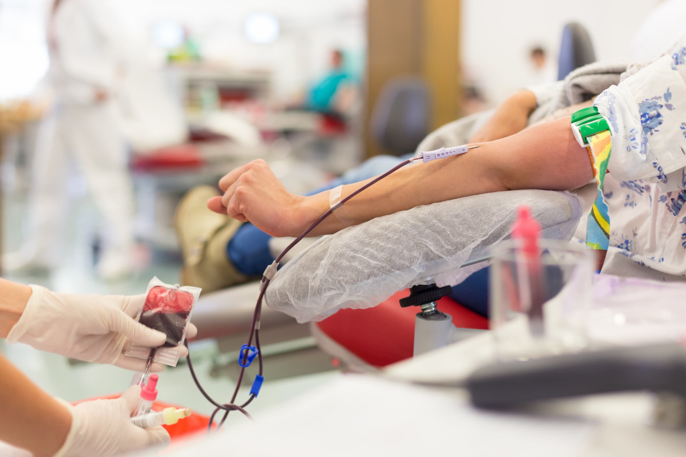 patient laying in infusion therapy getting blood transfusion through iv in her arm