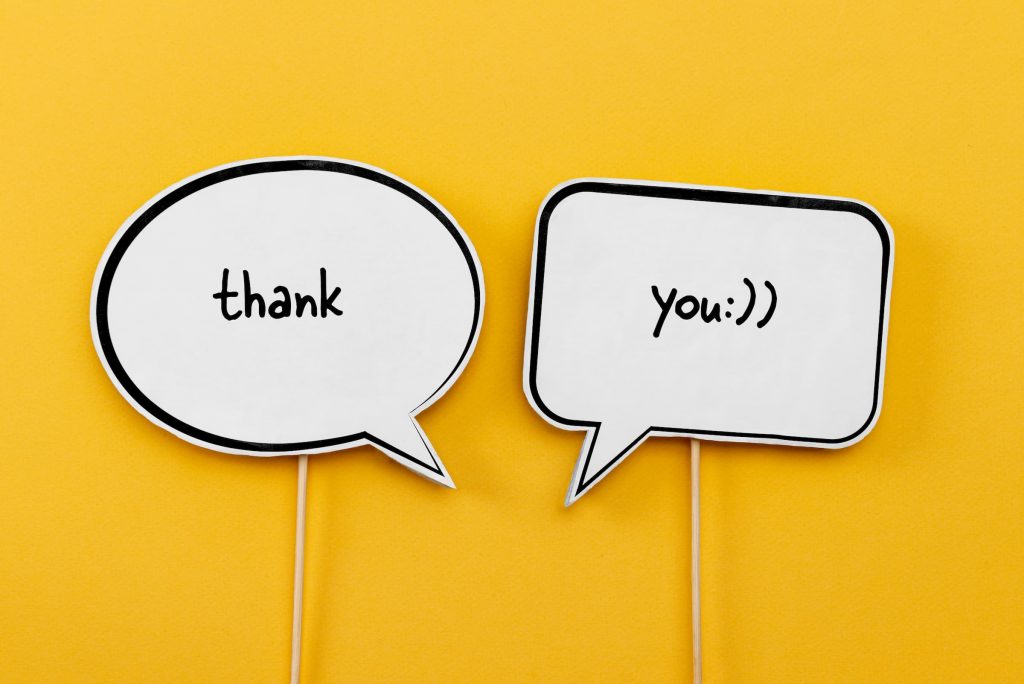 yellow back ground with speech bubble saying thank you