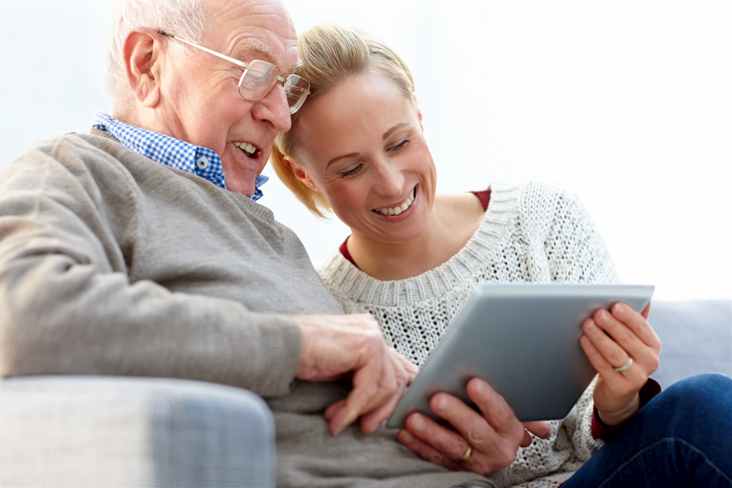 white senior man with white young female woman looking at ipad/tablet for alzheimer's & diabetes support group event
