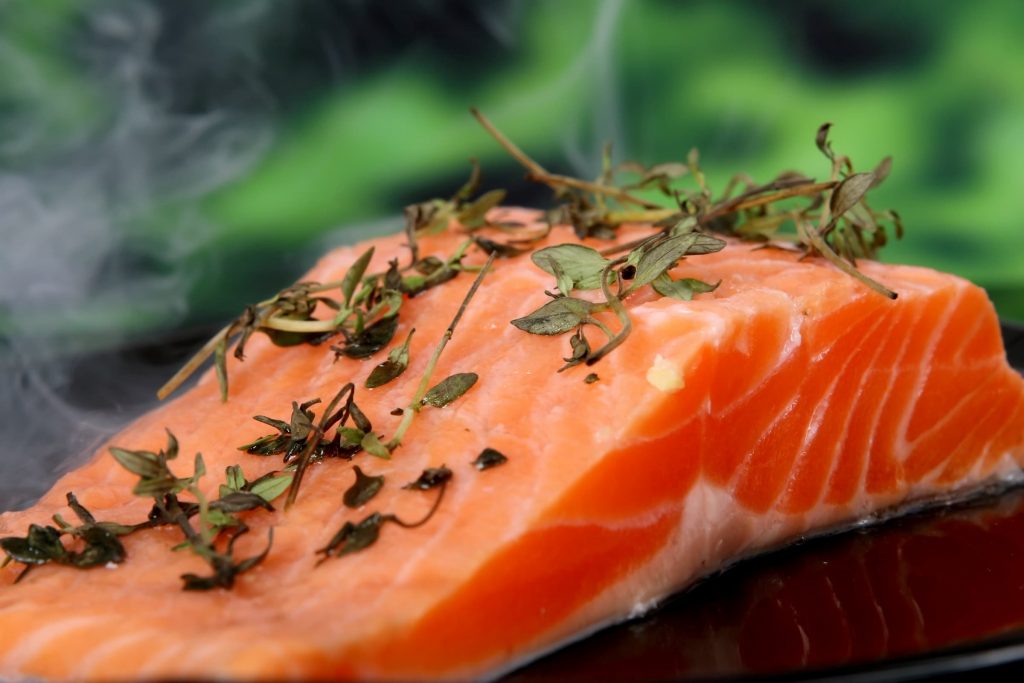 salmon filet with parsely on top close up food fish fatty acids and heart-healthy recipes healthy fats