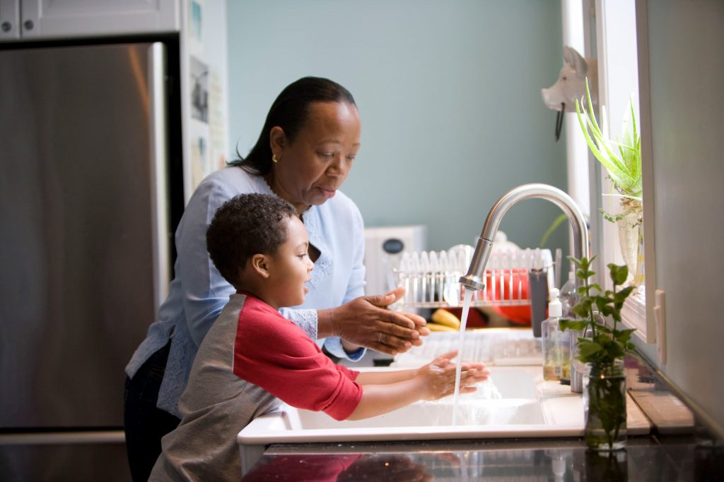 dad, little boy, washing hands, teaching, kitchen, COVID, sick, flu, cold, prevention, black