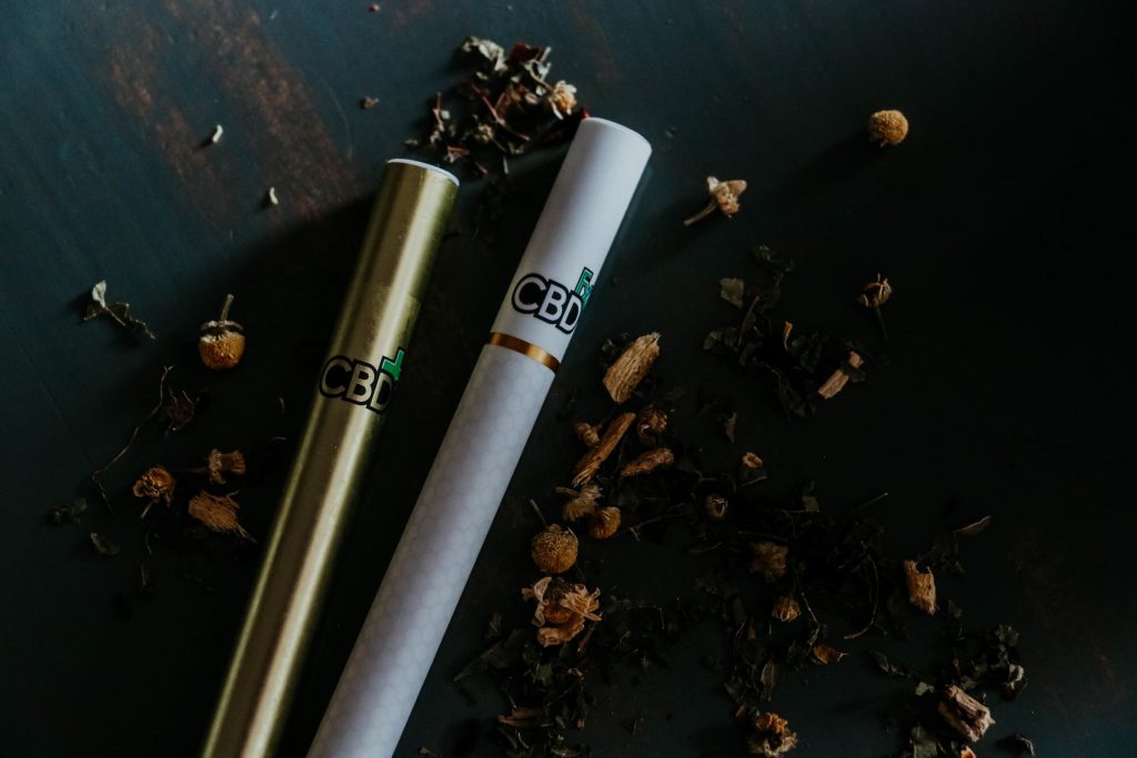 two vape pens with cbd thc marijuana products smoking vaping