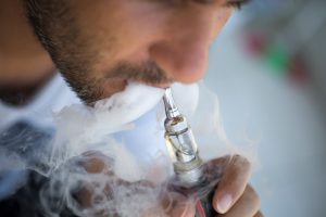 5 things you need to know about vaping man blowing smoke out of vape mod e-cigarette more addictive than cigarettes