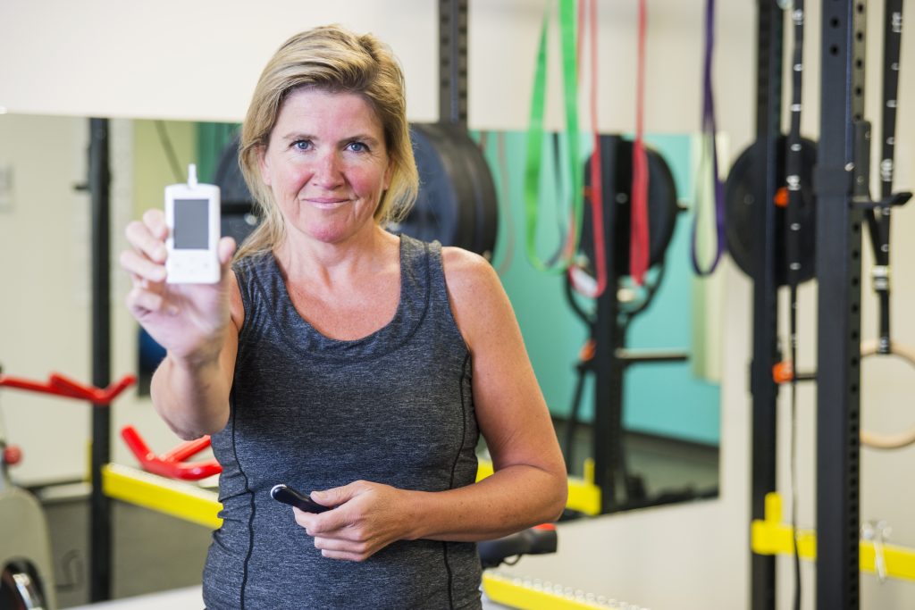 middle-aged white woman working out exercising and taking blood sugar to show how exercise affects blood sugar