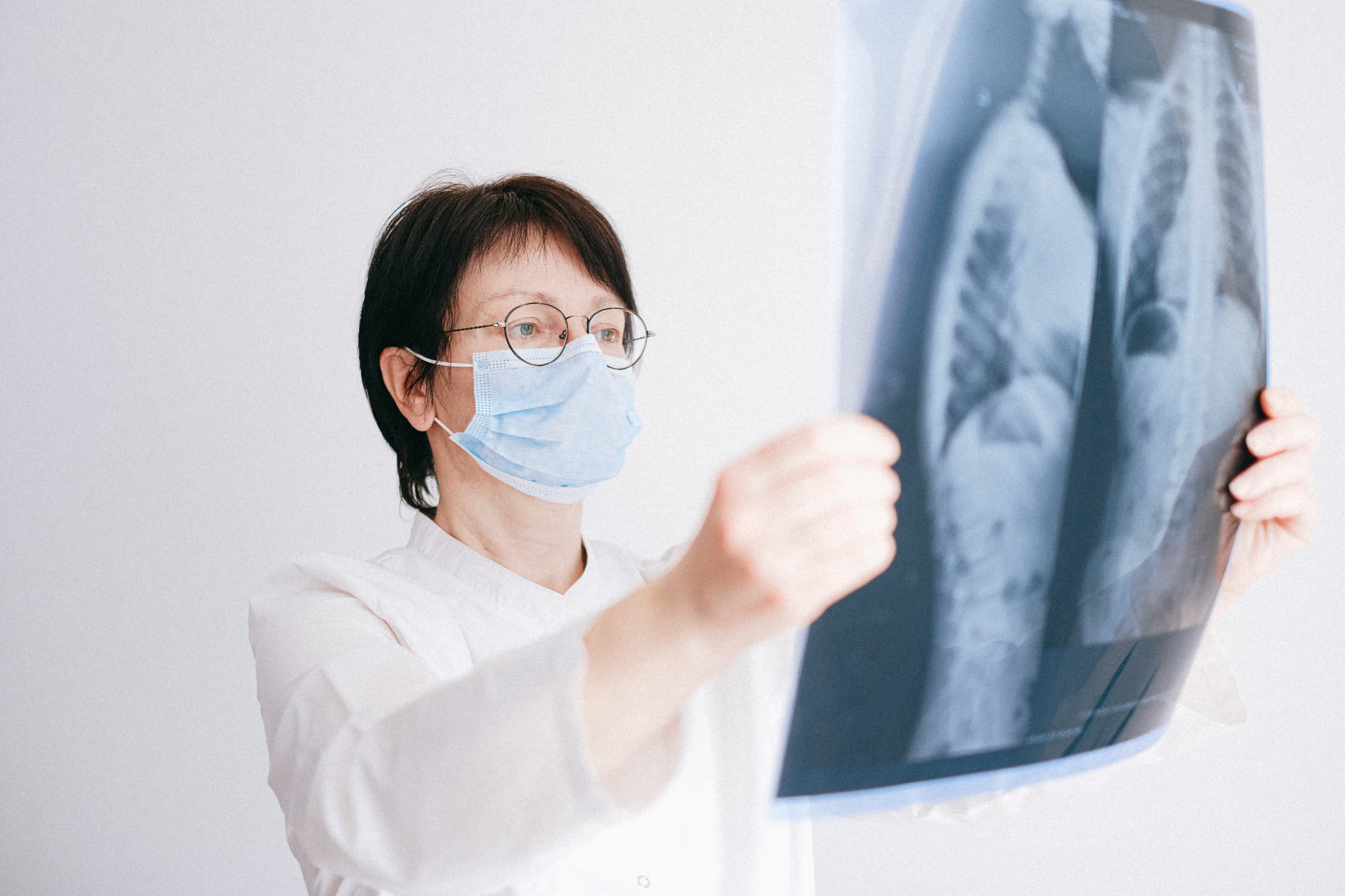 white female doctor holding up chest x-ray for better breathers club lung support group