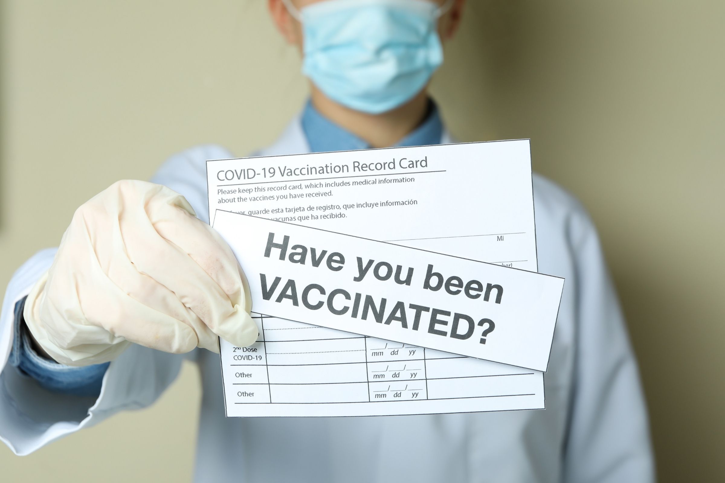 vaccine card held by doctor with "have you been vaccinated" picture