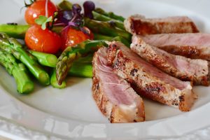 delicious health food recipe on plate meat with taomatoes and asparagus carb counting diet and exercise for managing diabetes