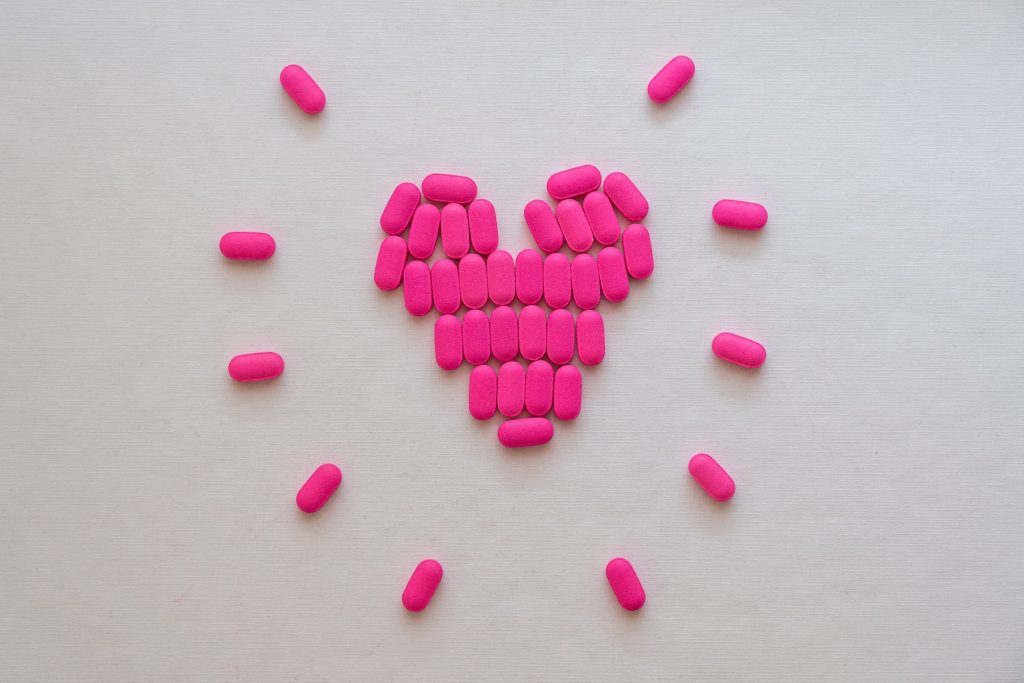 benadryl allergy medicine placed on white background in shape of a heart with rays coming out like the sun