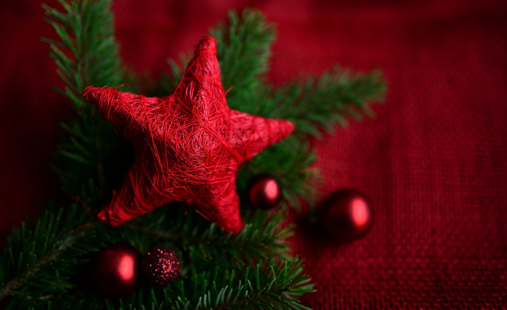 Red star tree topper with holiday decorations all around