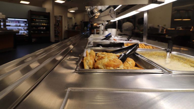 Warm biscuits and gravy on a stainless steel food distribution system sunflower café