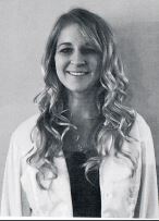 Woman in white sweater smiling