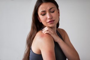 Woman Scratching Rash on Shoulder