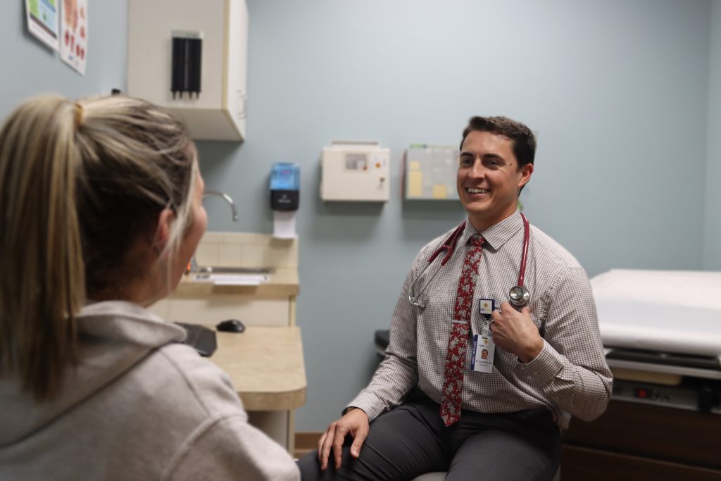doctor consulting a patient in clinic exam room at valley center