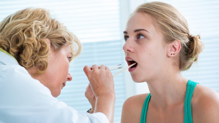 patient being examined by a family medicine provider or an ent doctor