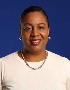 a woman wearing a pearl necklace and a white shirt