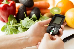 diabetes monitor, diet and healthy food eating nutritional concept with clean fruits and vegetables with diabetic measuring tool