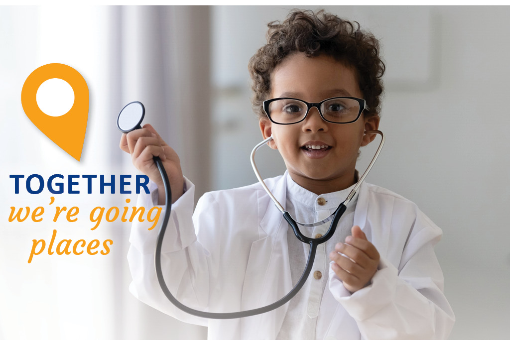a young boy wearing glasses and a white coat holding a stethoscope