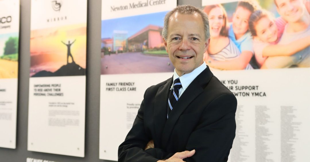 smiling gentleman in business suit with crossed arms