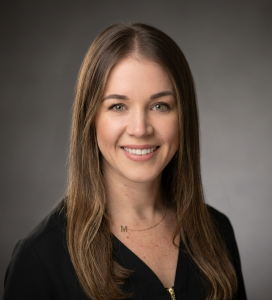 a woman with long brown hair and a necklace
