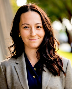 woman in a suite smiling outside