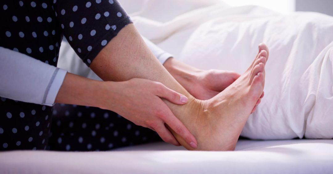 a person holding a foot, tendon pain, planter fasciitis pain
