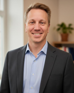 a man in a suit smiling