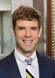 Man in suite with brown hair smiling