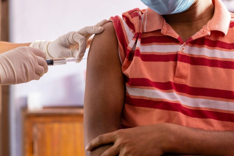 Vaccination – Black Man black man getting vaccine covid-19 vaccine who should get it